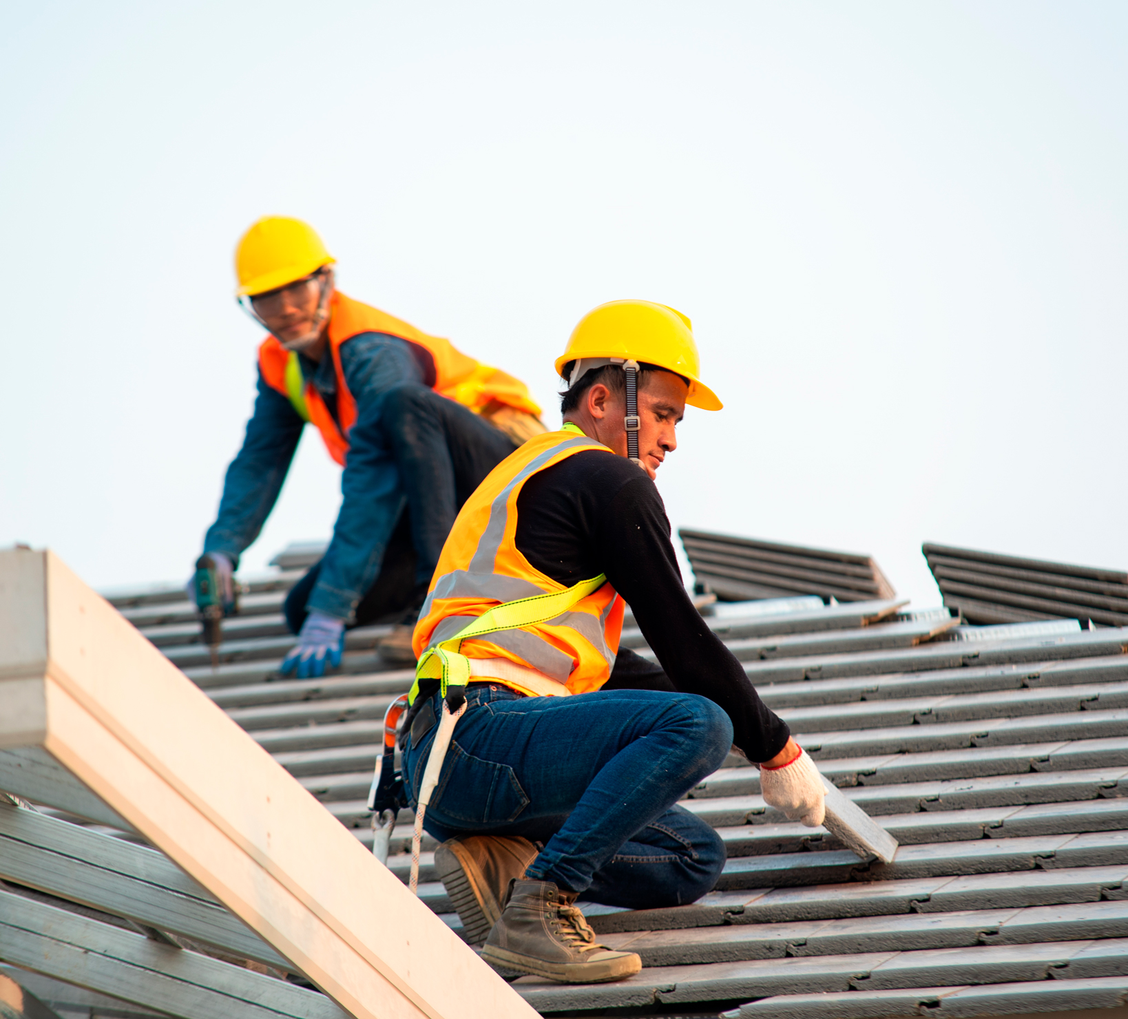 men working on shingle roof