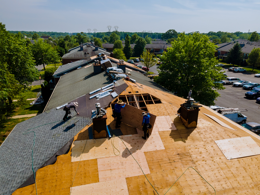Men replacing roofing